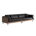 Divano moderno in pelle largo 270 cm con struttura in legno massello, gambe in metallo e 3 cuscini decorativi, nero